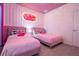This bedroom boasts pink themed decor, and two comfortable twin beds at 6240 Sand Skipper Rd, Orlando, FL 32821