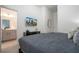 Comfortable bedroom featuring a plush bed, sleek dresser, modern decor, and an ensuite bathroom for convenience at 6240 Sand Skipper Rd, Orlando, FL 32821
