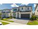 Beautiful two-story home boasts modern design, an attached two-car garage, and a paved driveway and walkway at 6240 Sand Skipper Rd, Orlando, FL 32821