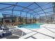 Outdoor screened pool with lounge chairs and a view of the surrounding neighborhood at 6240 Sand Skipper Rd, Orlando, FL 32821