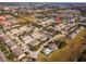 An aerial view of a neighborhood featuring several townhomes, beautiful landscaping, and a resort style community pool and cabana at 13228 Daniels Landing Cir, Winter Garden, FL 34787