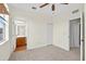 Spacious bedroom with neutral carpet, ceiling fan, and adjacent bathroom and closet entrances at 13228 Daniels Landing Cir, Winter Garden, FL 34787