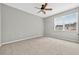 Bedroom with a ceiling fan, carpet floor, and double windows at 13228 Daniels Landing Cir, Winter Garden, FL 34787