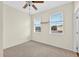 Bright bedroom with neutral carpet, ceiling fan, and windows providing ample natural light at 13228 Daniels Landing Cir, Winter Garden, FL 34787