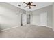 Spacious bedroom with a ceiling fan, carpet floor, and two closet doors at 13228 Daniels Landing Cir, Winter Garden, FL 34787