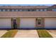 Close-up view of a townhome garages with clean driveways and manicured lawn at 13228 Daniels Landing Cir, Winter Garden, FL 34787