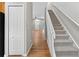 Hallway with wood-look floors, a staircase, and a view into the living room at 13228 Daniels Landing Cir, Winter Garden, FL 34787
