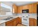 Bright kitchen with white countertops, oak cabinets, and white appliances at 13228 Daniels Landing Cir, Winter Garden, FL 34787