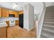 Cozy kitchen with wood cabinets, laminate floor, black fridge, and white oven range at 13228 Daniels Landing Cir, Winter Garden, FL 34787