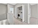 Hallway laundry room with white washer and dryer and bi-fold doors at 13228 Daniels Landing Cir, Winter Garden, FL 34787