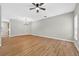 Expansive living room with wood-look flooring, contemporary light fixture, and a neutral color palette at 13228 Daniels Landing Cir, Winter Garden, FL 34787