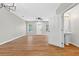 Bright living room with wood-look flooring, ceiling fan, and natural light from two windows at 13228 Daniels Landing Cir, Winter Garden, FL 34787