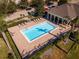 A view of the community pool featuring lounge chairs, an elegant pool cabana, and manicured landscaping throughout at 13228 Daniels Landing Cir, Winter Garden, FL 34787