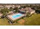 A view of the community pool featuring lounge chairs, an elegant pool cabana, and beautiful landscaping throughout at 13228 Daniels Landing Cir, Winter Garden, FL 34787