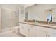 Bathroom with double vanity and walk-in shower at 571 Drop Shot Dr, Davenport, FL 33896