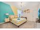 Bright bedroom with a zig-zag patterned bedspread and accent wall at 571 Drop Shot Dr, Davenport, FL 33896