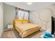 Bedroom with a queen-size bed and accent wall at 571 Drop Shot Dr, Davenport, FL 33896