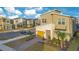 Two-story house with yellow garage door and landscaped yard at 571 Drop Shot Dr, Davenport, FL 33896