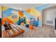 Game room with colorful walls and a comfy couch at 571 Drop Shot Dr, Davenport, FL 33896