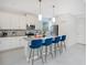 Modern kitchen with white cabinets, island, and breakfast bar at 571 Drop Shot Dr, Davenport, FL 33896