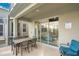Covered patio with table and chairs, view to living area at 571 Drop Shot Dr, Davenport, FL 33896