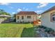 Backyard with well-maintained lawn and stucco home at 728 Palm Dr, Orlando, FL 32803
