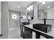 Elegant bathroom with double vanity, black sinks, and a walk-in shower at 728 Palm Dr, Orlando, FL 32803
