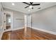 Hardwood floor bedroom with ceiling fan and mirrored closet at 728 Palm Dr, Orlando, FL 32803