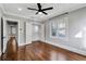 Hardwood floor bedroom with ceiling fan and double door closet at 728 Palm Dr, Orlando, FL 32803