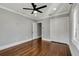 Hardwood floor bedroom with ceiling fan and double door closet at 728 Palm Dr, Orlando, FL 32803