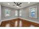 Hardwood floor bedroom with ceiling fan and multiple windows at 728 Palm Dr, Orlando, FL 32803