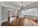 Sunlit dining room with hardwood floors and arched doorways at 728 Palm Dr, Orlando, FL 32803