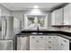 Modern kitchen with white cabinets and stainless steel appliances at 728 Palm Dr, Orlando, FL 32803