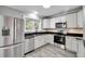 Modern kitchen with white cabinets and stainless steel appliances at 728 Palm Dr, Orlando, FL 32803