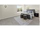 Bright bedroom featuring soft carpet, side tables, and natural light from the two large windows at 813 S Locust Ave, Sanford, FL 32771