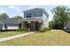 Well-maintained home featuring gray siding, complemented by a well manicured lawn and brick accents at 813 S Locust Ave, Sanford, FL 32771