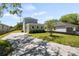 Beautiful home showcasing a garage, a paved driveway, lush green grass, and an inviting exterior at 813 S Locust Ave, Sanford, FL 32771