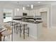 Bright kitchen features a breakfast bar, stainless steel appliances, and modern pendant lighting at 813 S Locust Ave, Sanford, FL 32771