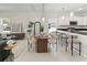 Stylish dining area seamlessly connected to a modern kitchen and a view of the living room at 813 S Locust Ave, Sanford, FL 32771