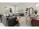 Bright living room showcasing stylish seating, with smooth transition to the dining area and lots of natural light at 813 S Locust Ave, Sanford, FL 32771