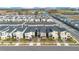 Aerial view of community with houses and lake at 1179 Kingsbarn St, Davenport, FL 33896