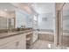 Bathroom with double vanity, soaking tub, and shower at 1179 Kingsbarn St, Davenport, FL 33896