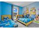 bedroom with twin beds and Minions mural at 1179 Kingsbarn St, Davenport, FL 33896