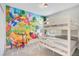 Bedroom with bunk beds and Disney mural at 1179 Kingsbarn St, Davenport, FL 33896