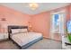 Bedroom with king bed and pink accent wall at 1179 Kingsbarn St, Davenport, FL 33896