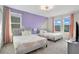 Bedroom with two twin beds and purple accent wall at 1179 Kingsbarn St, Davenport, FL 33896