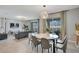 Modern dining room with a round table and gray chairs, near the living room at 1179 Kingsbarn St, Davenport, FL 33896