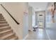 Bright entryway with tile flooring, stairs, and bench at 1179 Kingsbarn St, Davenport, FL 33896