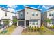 Two-story modern home with gray siding, landscaped yard, and paved walkway at 1179 Kingsbarn St, Davenport, FL 33896