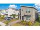Modern two-story home with gray exterior, landscaping, and driveway at 1179 Kingsbarn St, Davenport, FL 33896